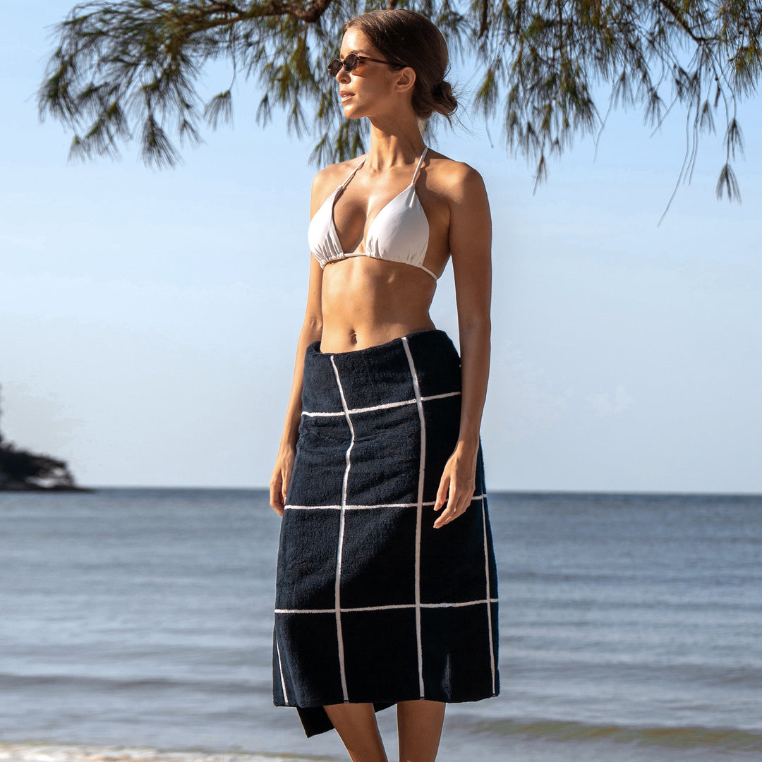 Navy cotton towel with white grid stripes, styled as a wrap skirt
