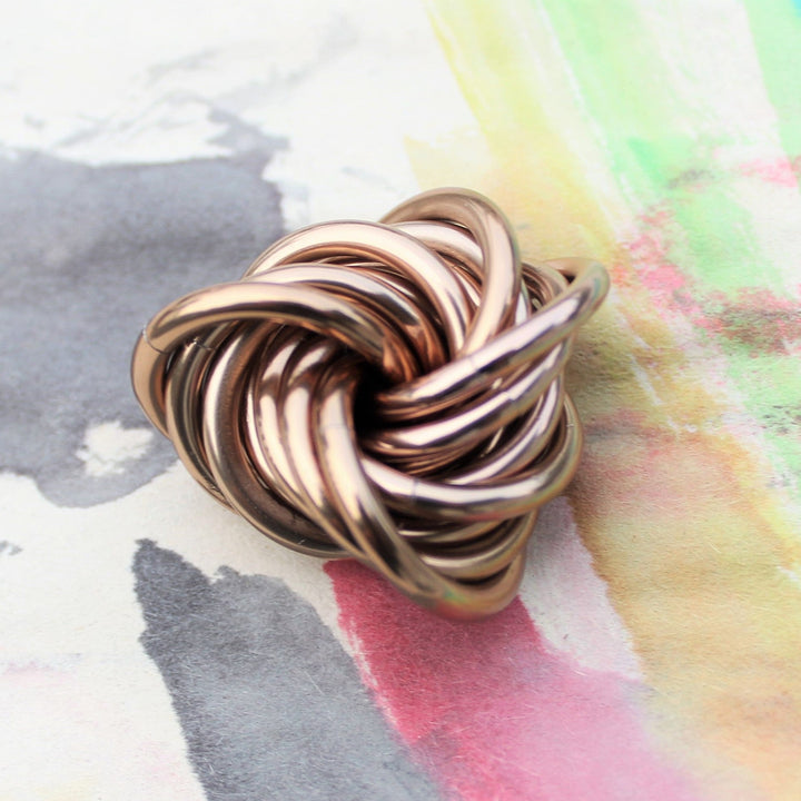 Gold metallic stress fidget ball with coiled loop design