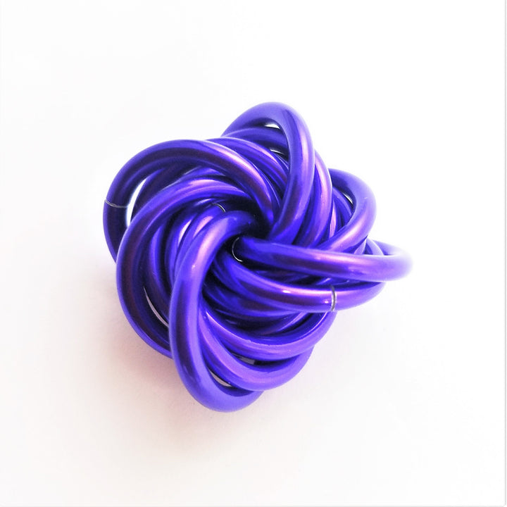 Swirled fidget stress ball, vibrant purple glossy loops with a curved protruding strand
