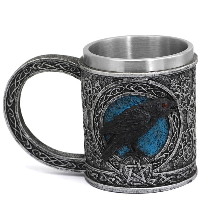 Stainless steel mug with raven-and-celtic knot relief, black finish, blue accents.
