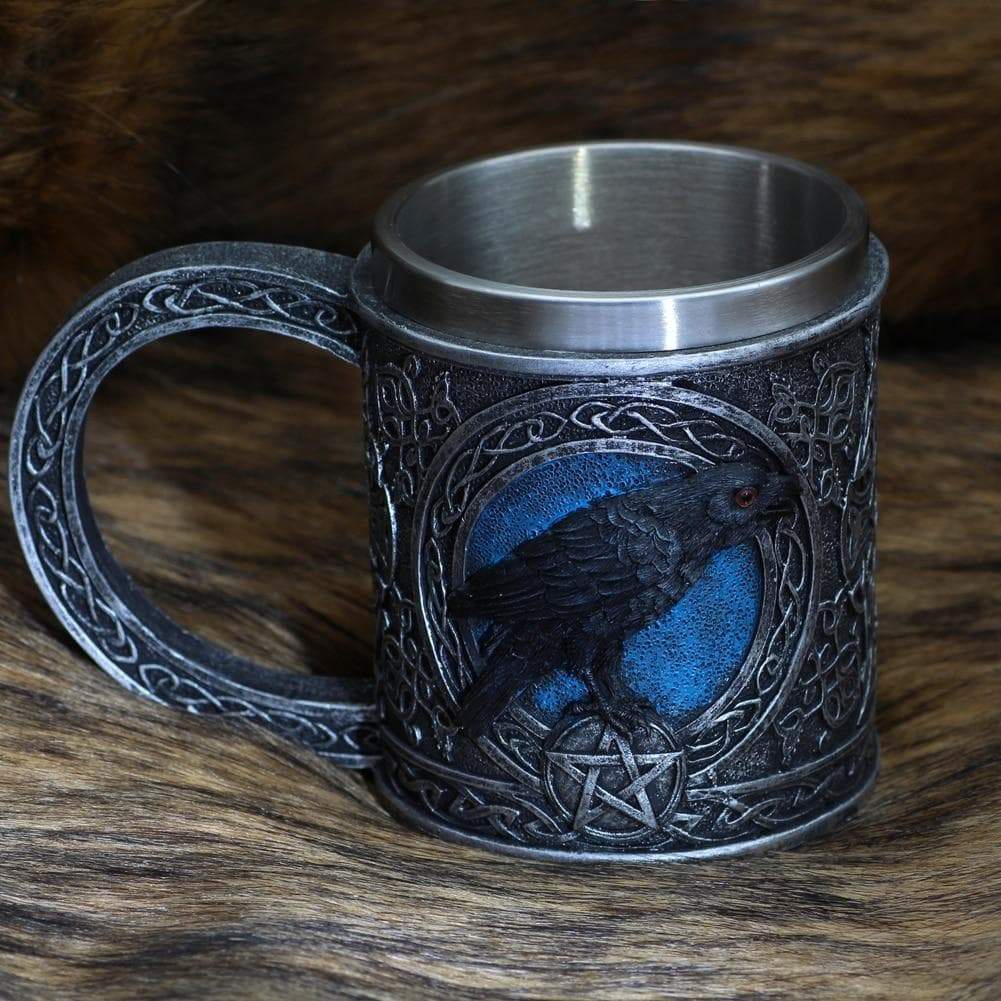 Stainless steel mug with raven emblem relief and blue accents, curved handle.