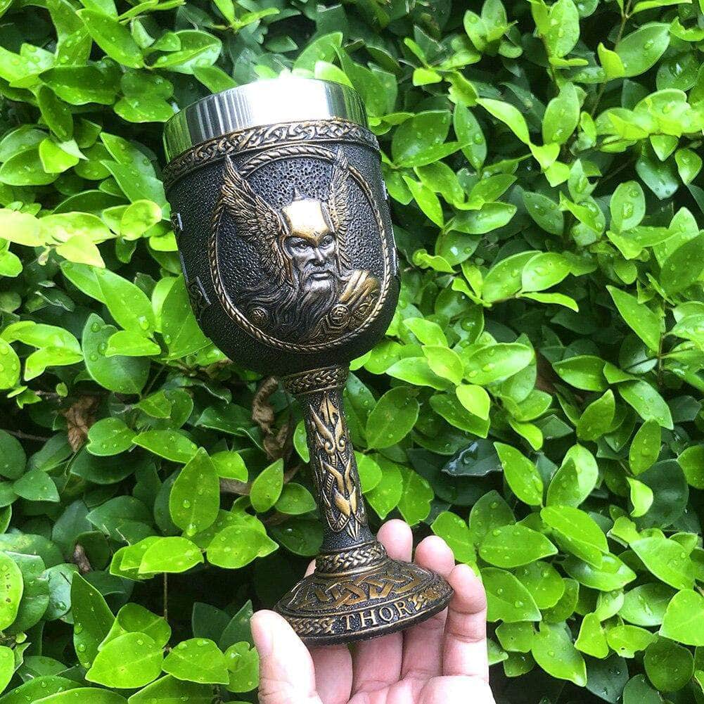 Thor drinking goblet, dark leather-style with engraved bearded face and metal rim.