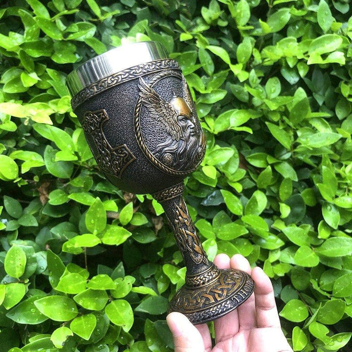 Thor drinking goblet with side engraved beard head and detailed bronze-toned base.