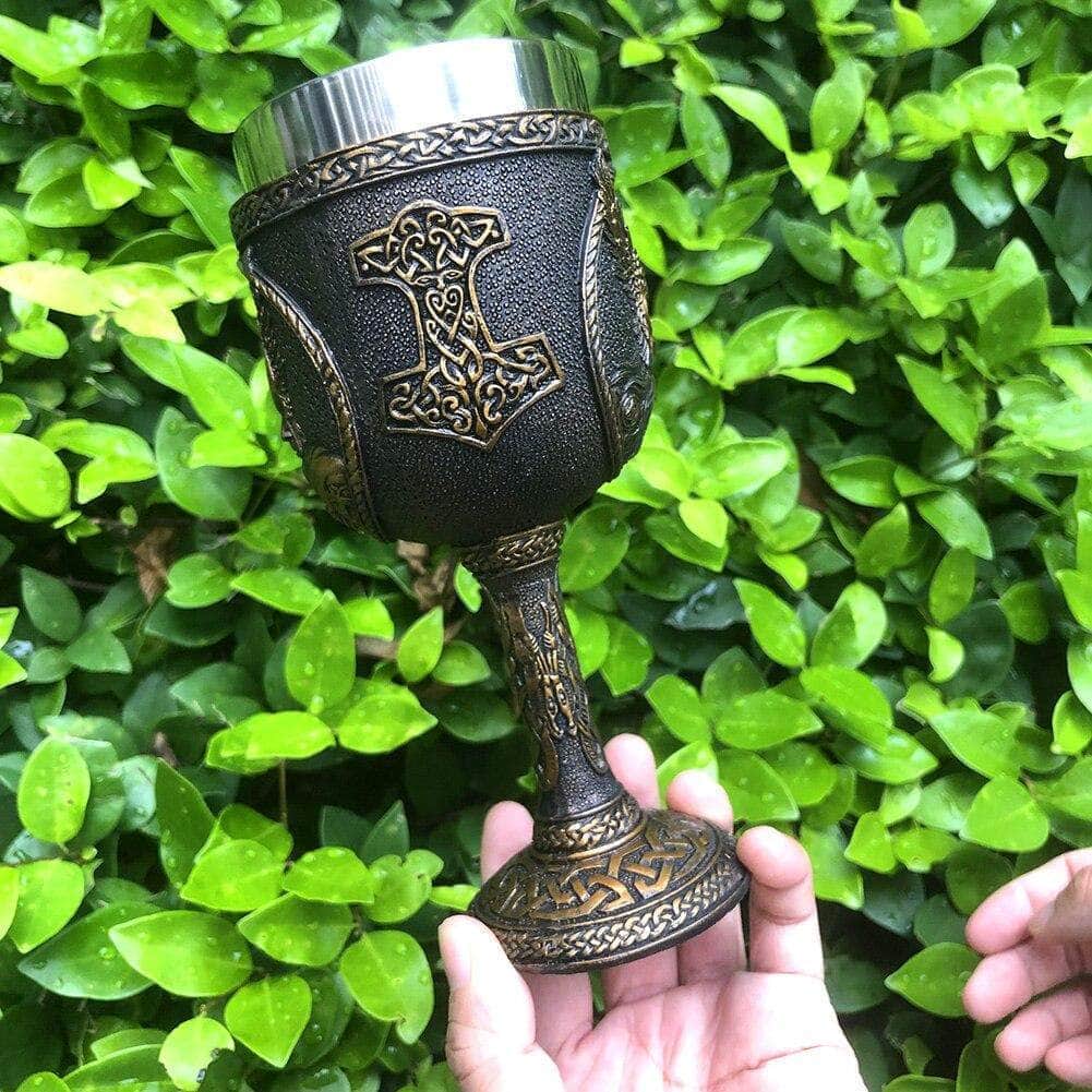Thor drinking goblet cup with central rune design and engraved bearded warrior face.