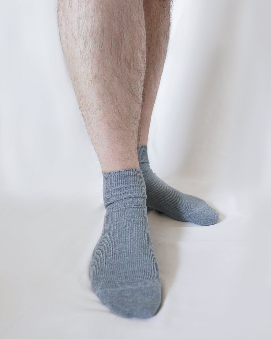 Men’s organic cotton crew socks in gray worn with ribbed knit