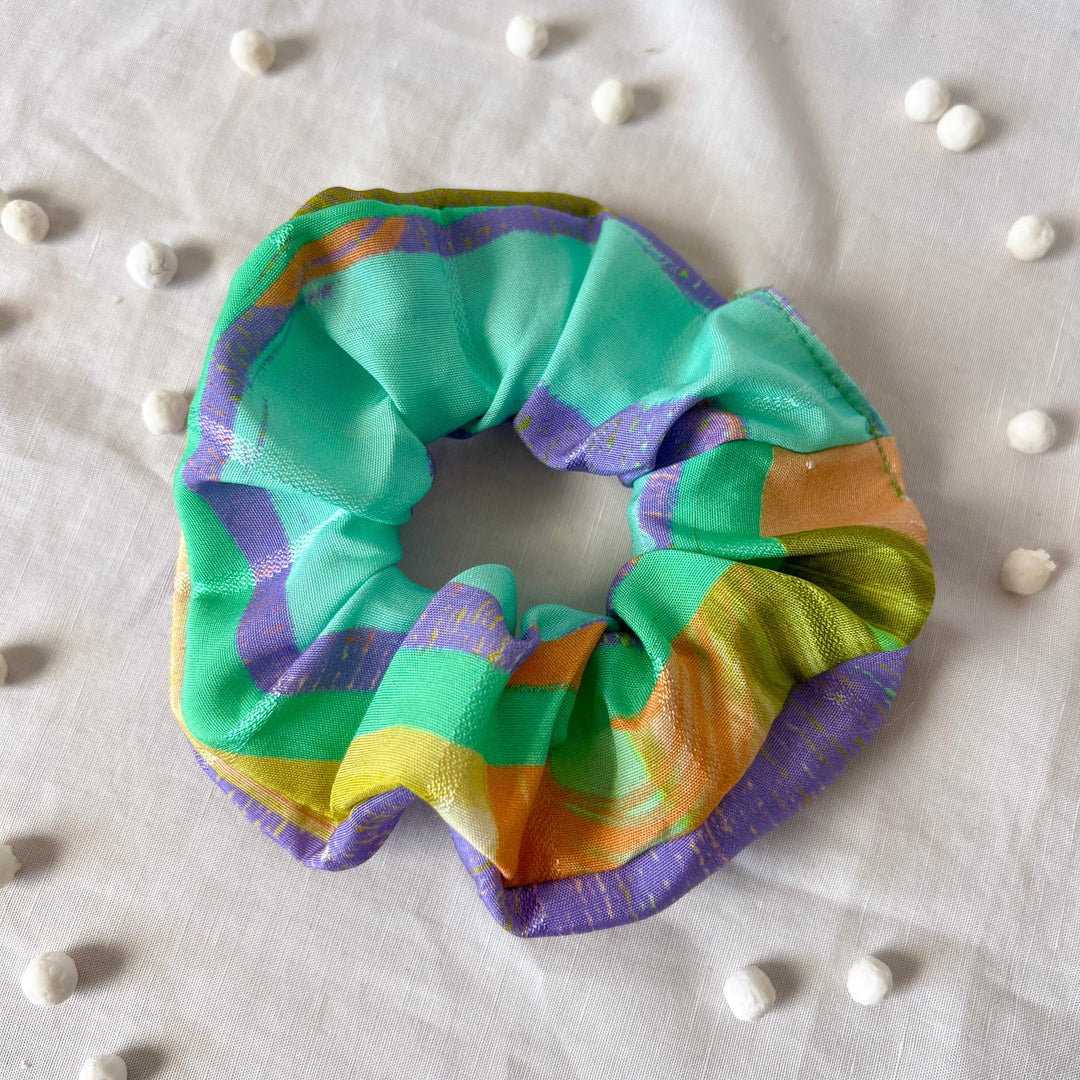 Colorful striped scrunchie with turquoise, purple, orange, and yellow loops