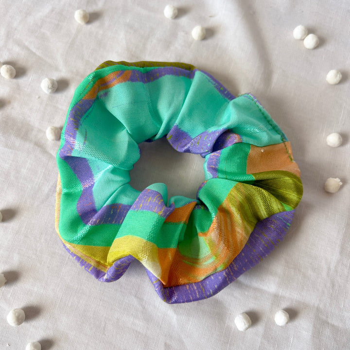 Colorful striped scrunchie with turquoise, purple, orange, and yellow loops