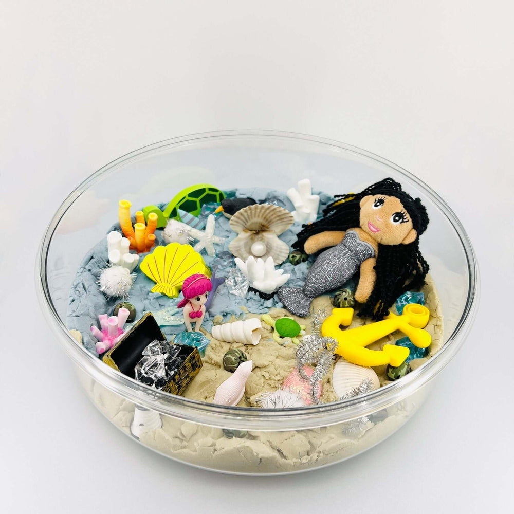 Bowl of mermaid kinetic sand play set accessories with figurines and sea items