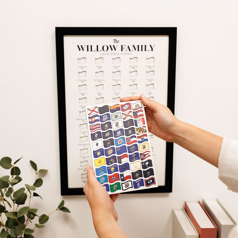 Framed travel tracker poster showing badge icons, hand applying a colorful badge sheet