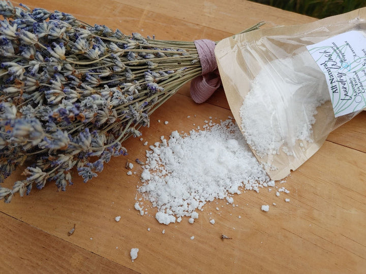 Natural laundry wash powder sachet with scattered laundry powder and lavender sprigs