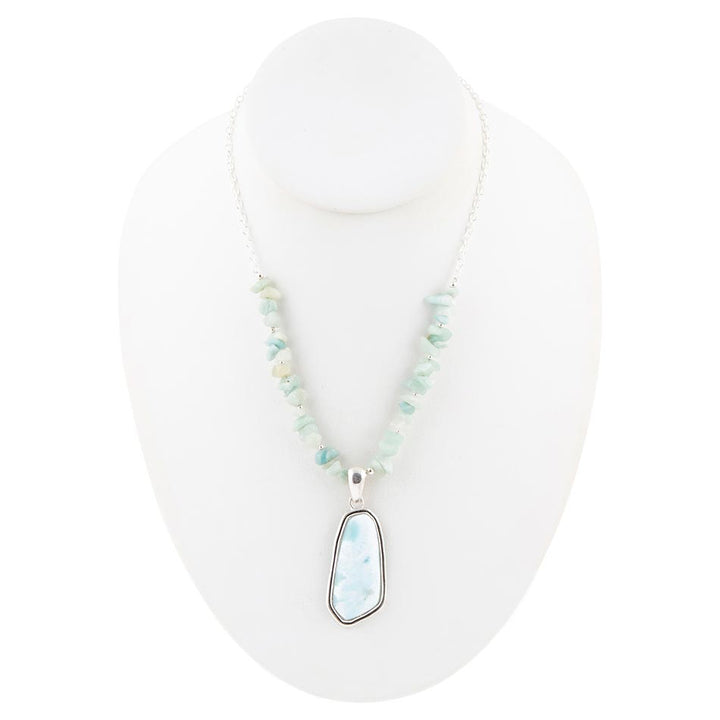 Sterling silver bead necklace with oval light-blue pendant shown on mannequin bust
