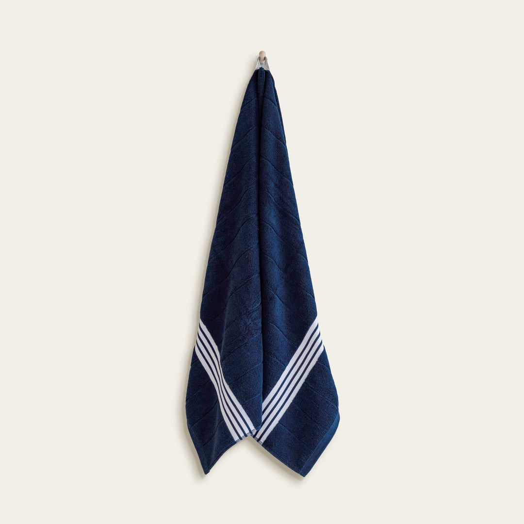 Hanging navy cotton towel with white stripe border