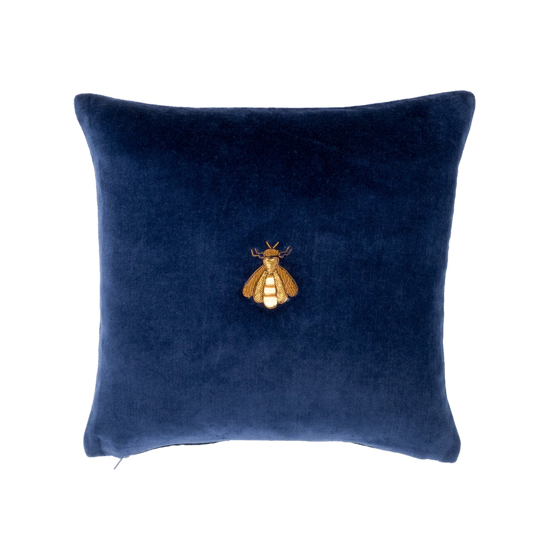 Navy velvet throw pillow cover with gold bee emblem at center