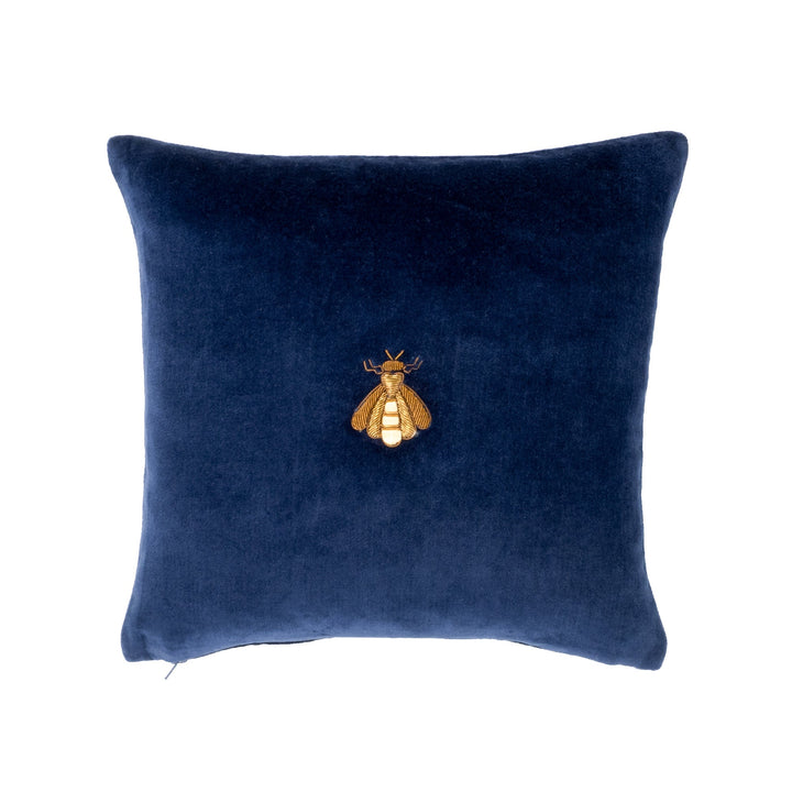 Navy velvet throw pillow cover with gold bee emblem at center