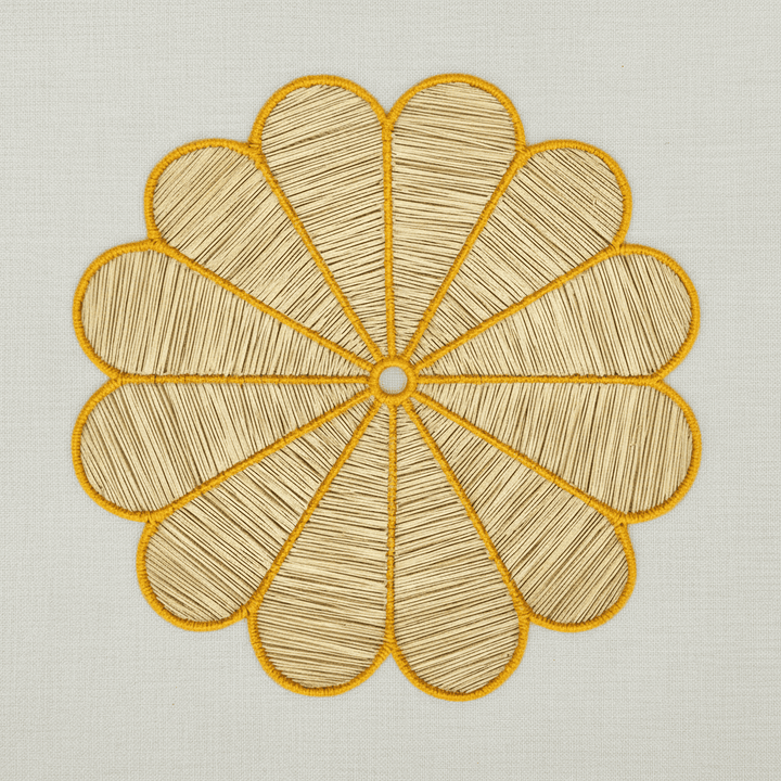 Handwoven iraca flower placemat with deep blue-stitched petals and a natural woven center.