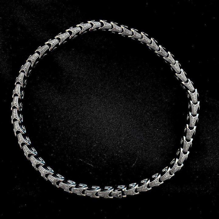 Ornate stainless steel chain necklace, full round view with engraved links