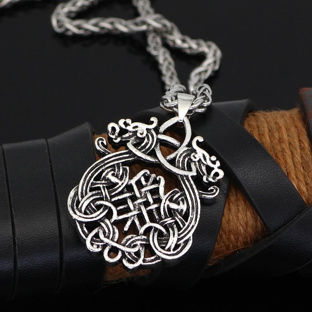 Large dragon-knot pendant with bail on stainless steel link chain necklace.