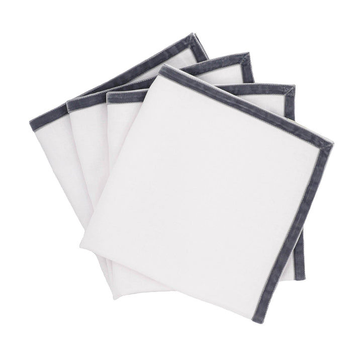 Set of 4 linen napkins with dark velvet borders, folded stack