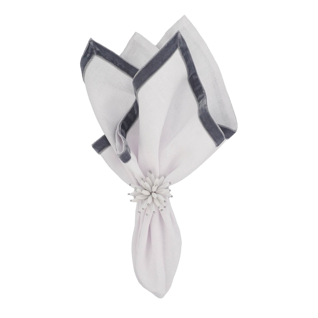 Linen napkins set, tied with a white flower napkin ring and dark border trim