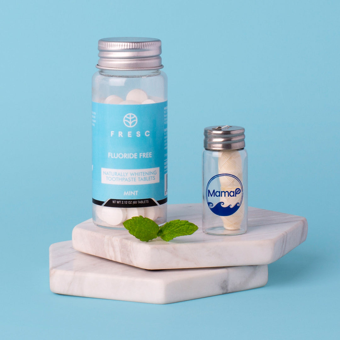Plastic-free dental floss starter set with large and small containers on stand