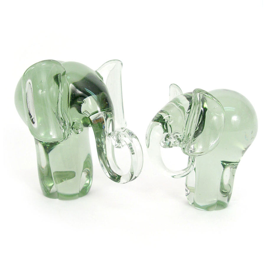 Recycled glass elephant figurines, two green translucent elephants with curved trunks