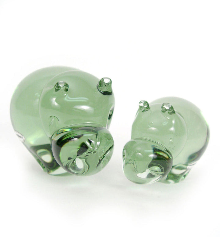 Green glass hippo figurines, two-piece pair with curved bodies and raised ears