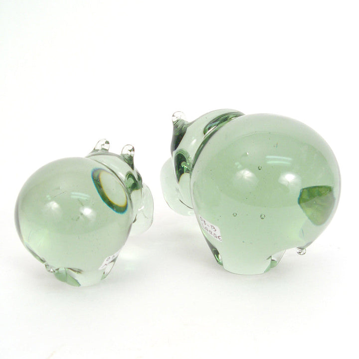 Green glass hippo figurines, front views with one large and one small hippo