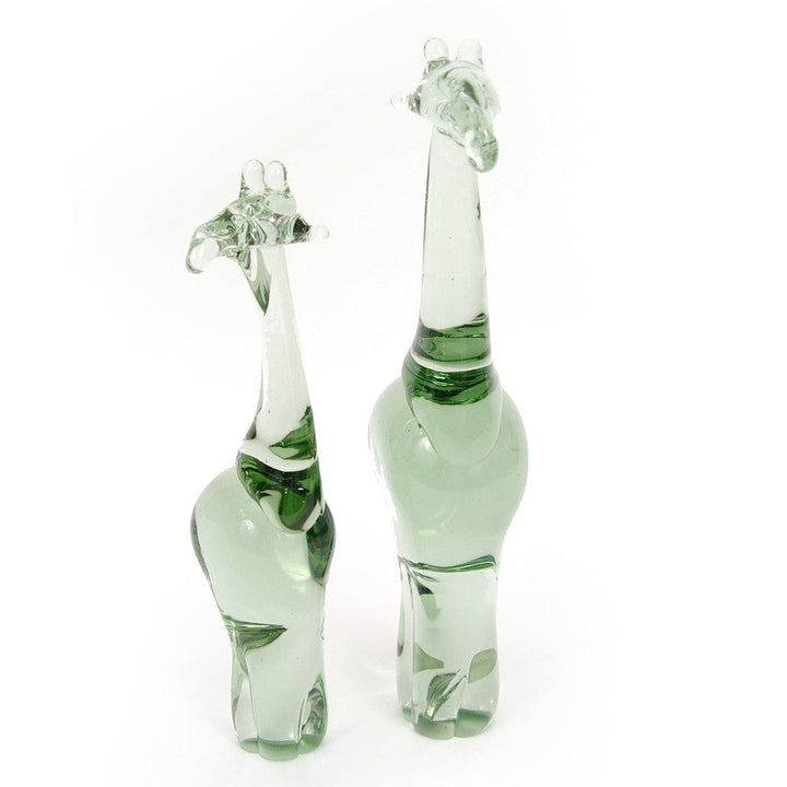 Pair of green recycled glass giraffe figurines with raised head and cutout details