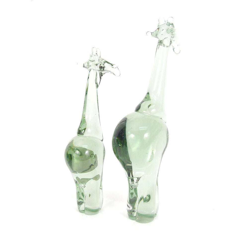 Two green recycled glass giraffe figurines, one small and one tall, standing