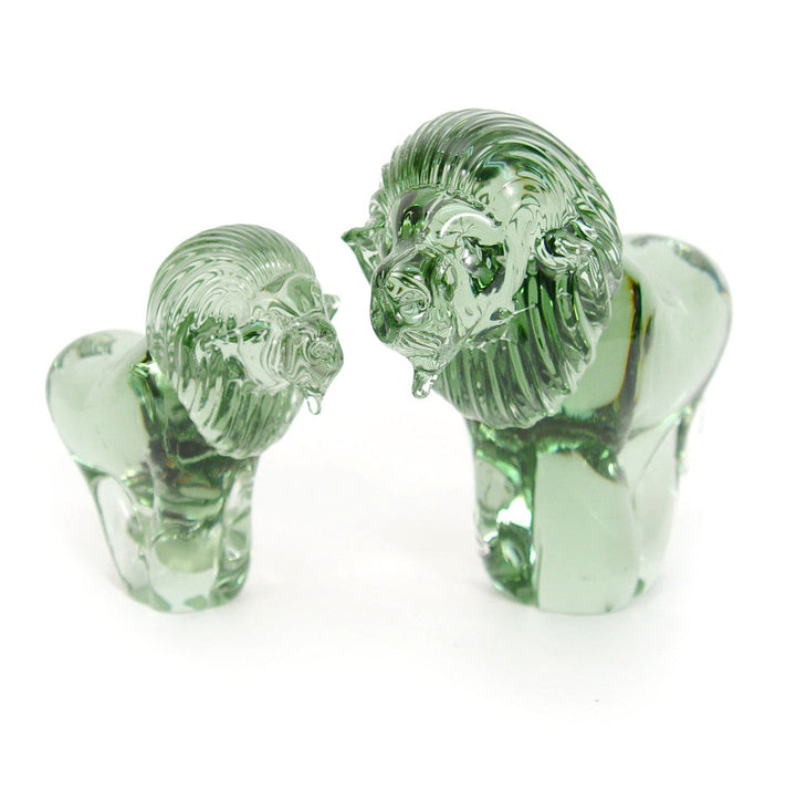Translucent green recycled-glass lion figurine, mouth open, tail curled.