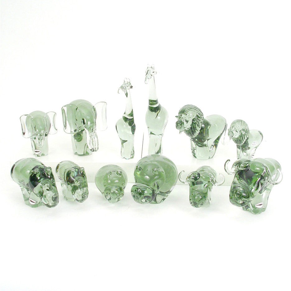 Recycled glass elephant figurines, multiple green translucent elephants standing in a row
