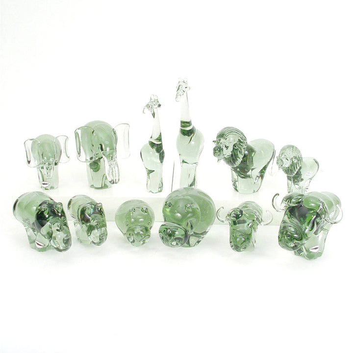 Recycled glass elephant figurines, multiple green translucent elephants standing in a row