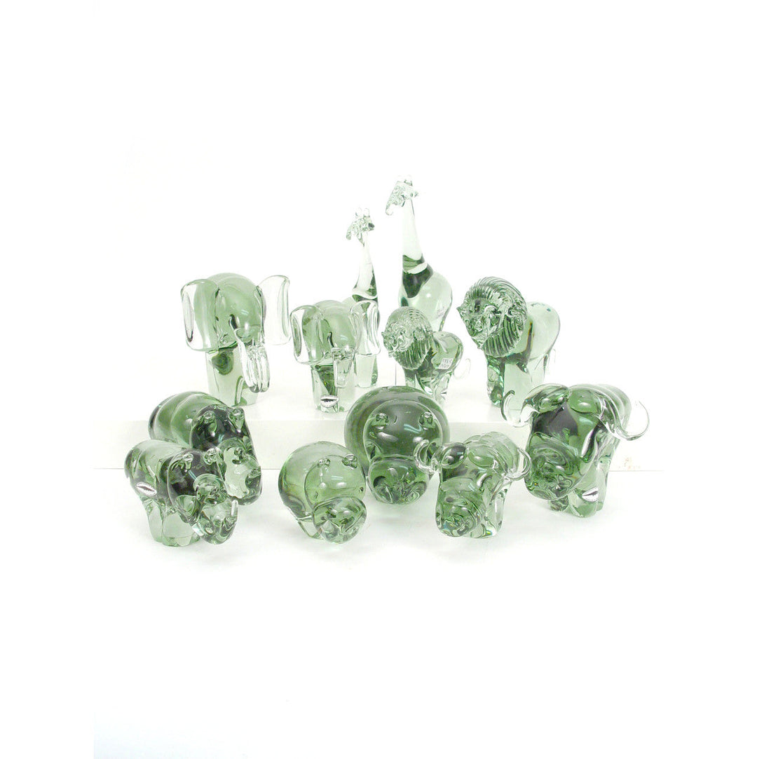 Group of small recycled glass animal figurines in translucent green, assorted shapes.