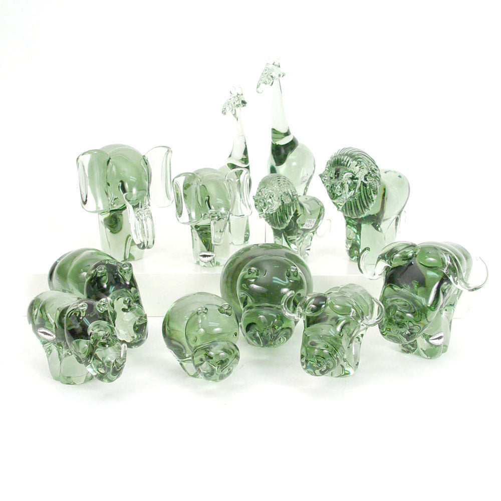Group of translucent green recycled-glass lion figurines, multiple standing pieces.