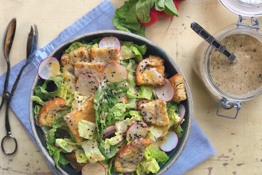 Nigella Caesar seasoning on Caesar salad with croutons and greens