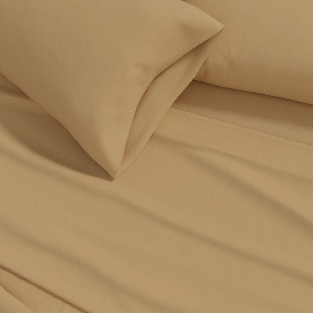 Camel cotton flannel sheet close-up with smooth fabric texture and draped folds