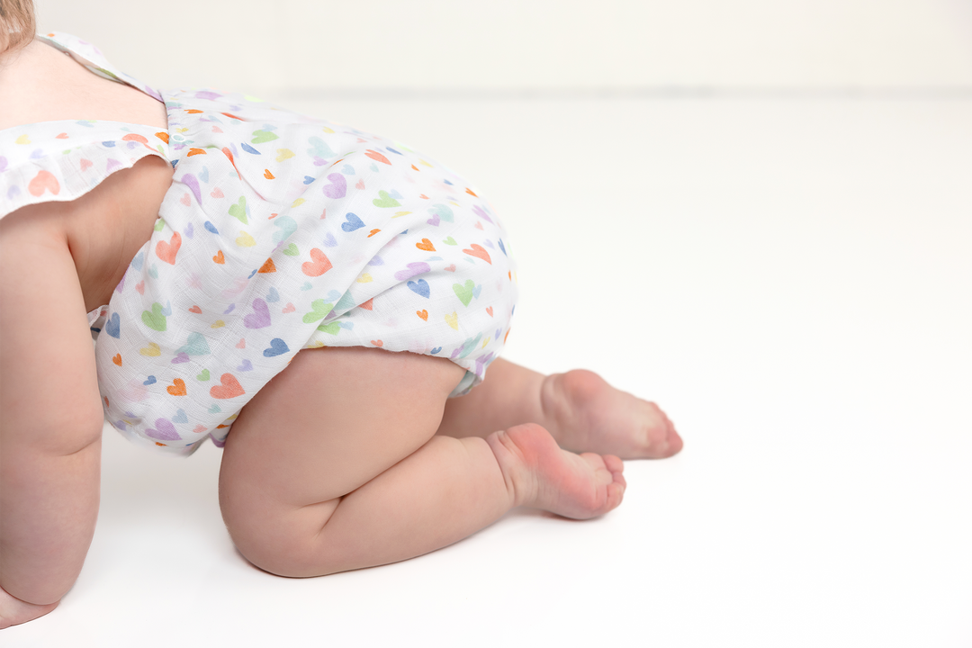 Heart-print muslin bubble romper with ruffle cap sleeves and gathered leg openings