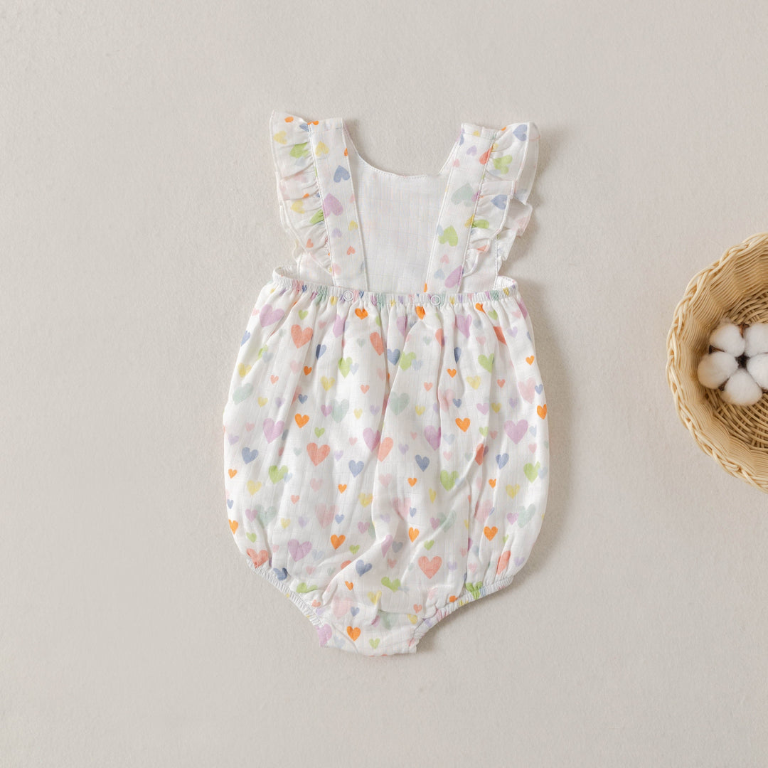Heart-print muslin bubble romper with gathered waist and ruffled cap sleeves