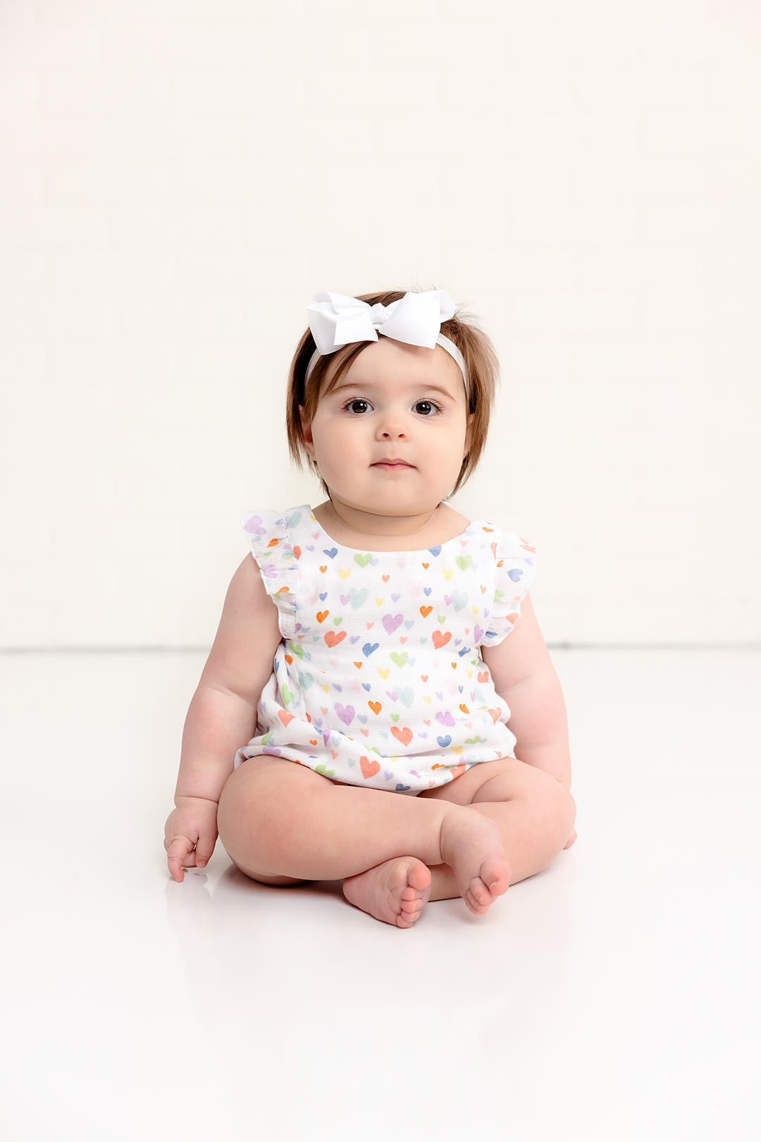 Heart-print muslin bubble romper on baby with bow headband