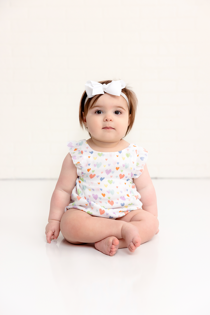 Heart-print muslin bubble romper on baby with bow headband