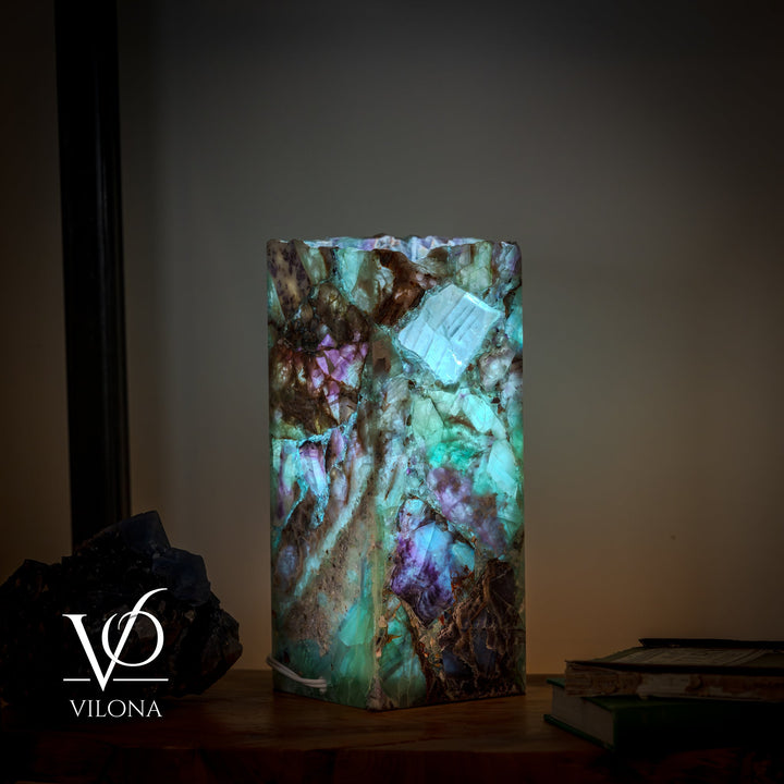 Fluorite table lamp with rectangular square shade in teal glow with purple accents