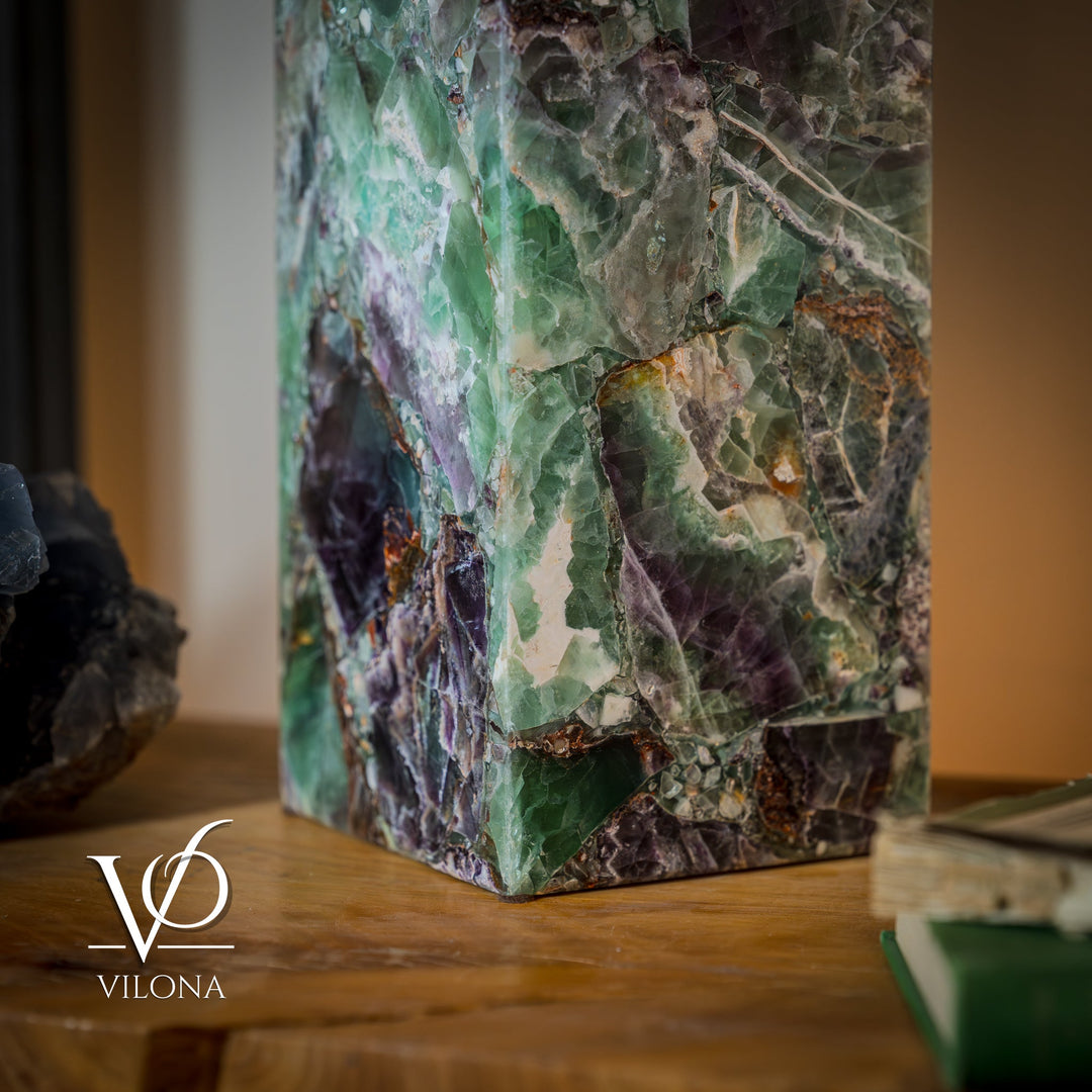 Fluorite table lamp corner view, faceted teal-green stone with purple and amber flecks.