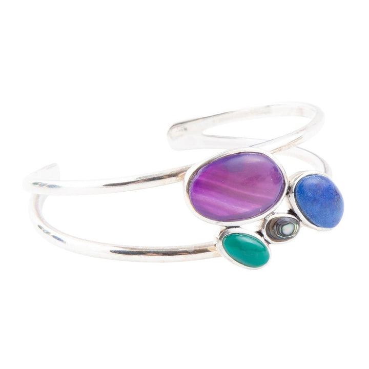 Sterling silver cuff bracelet with oval purple, blue, and green stones