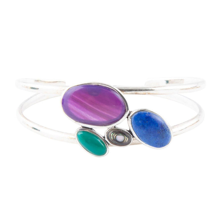 Sterling silver cuff bracelet featuring purple oval gemstone with blue and green stones