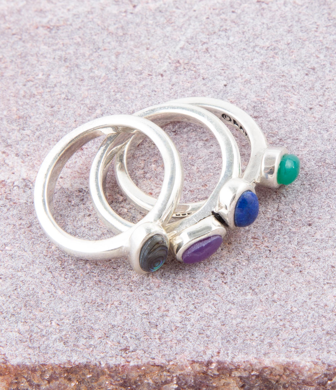 Sterling silver ring set with round blue, purple and green stones on silver bands