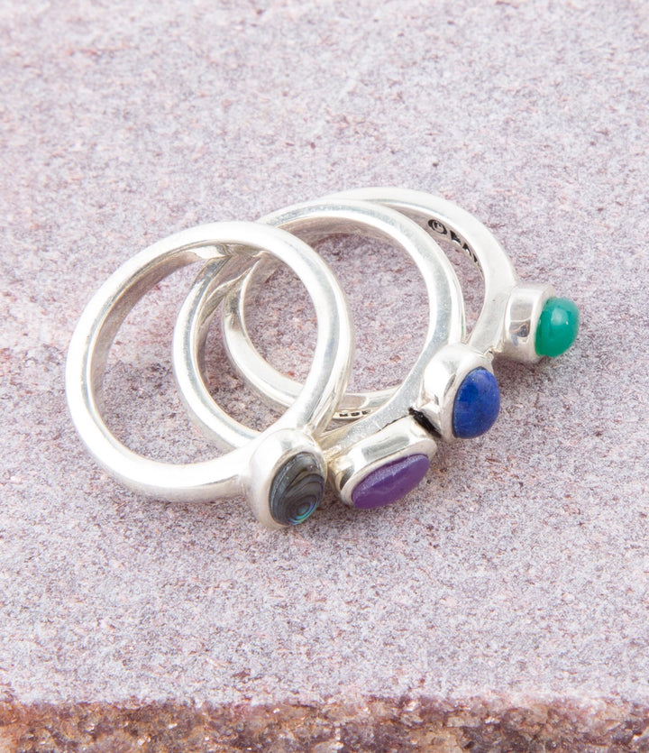 Sterling silver ring set with round blue, purple and green stones on silver bands