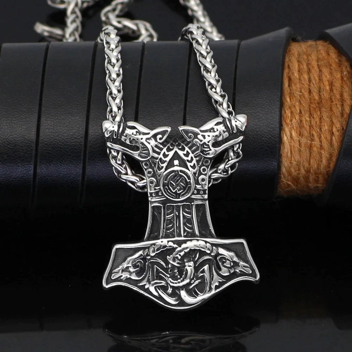 Silver Mjolnir pendant necklace with wolf-and-goat-head detailing and chain links