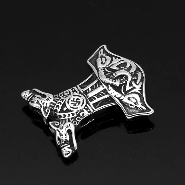 Silver Mjolnir pendant with wolf-and-goat-head motifs, side view