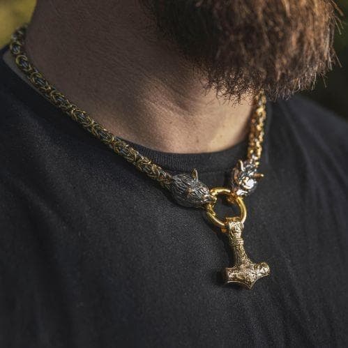 Viking wolf-head Mjolnir pendant necklace worn close-up with gold-tone chain
