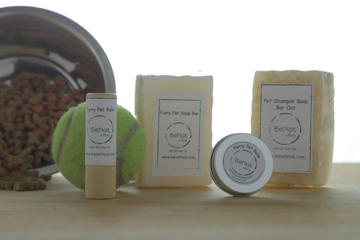 Pet balm stick and small round tin among other pet care items